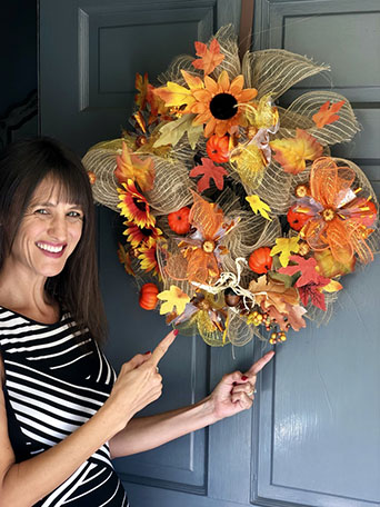 Gretchen Hydo with the fall wreath she made.